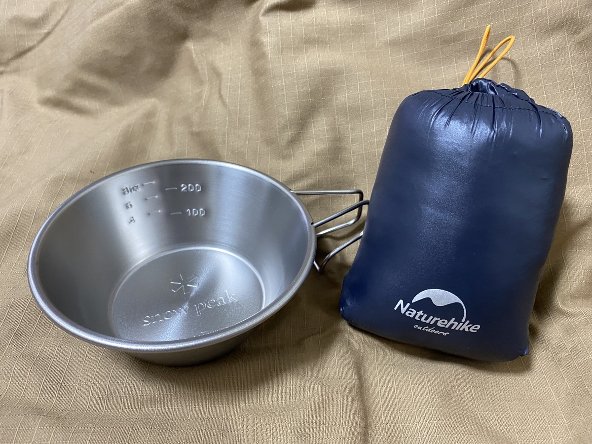 Down tent shoes and Sierra cups side by side