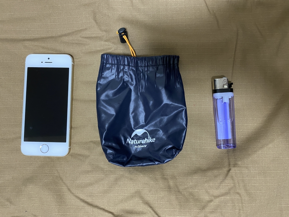 Storage bag lined up with iPhone SE and lighter