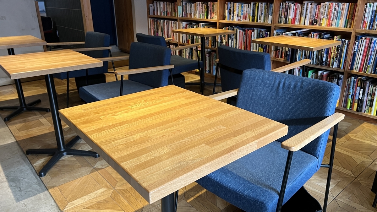 Single table and chair facing the aisle
