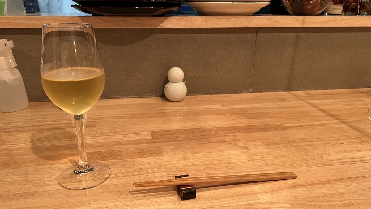 Counter seat with a wine glass and chopsticks placed