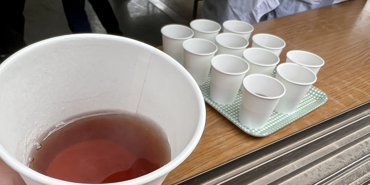 Warm tea in paper cups and tea service setup