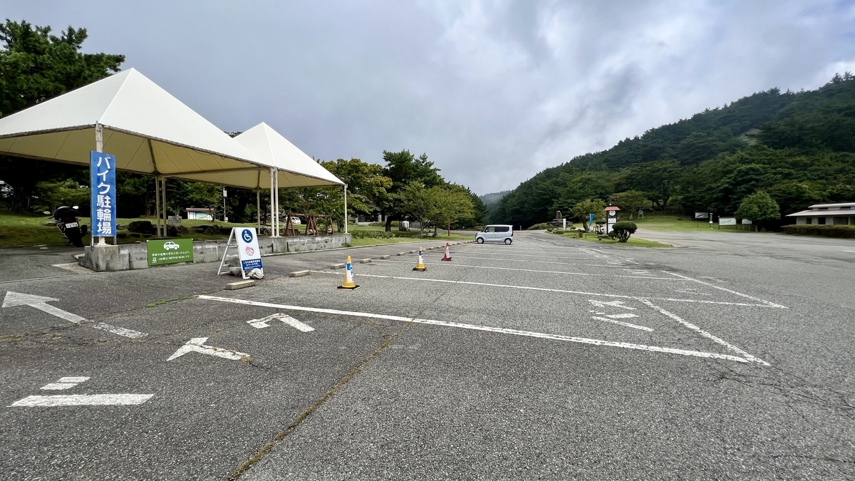Spacious parking area at Kankakei Gorge summit surrounded by mountains