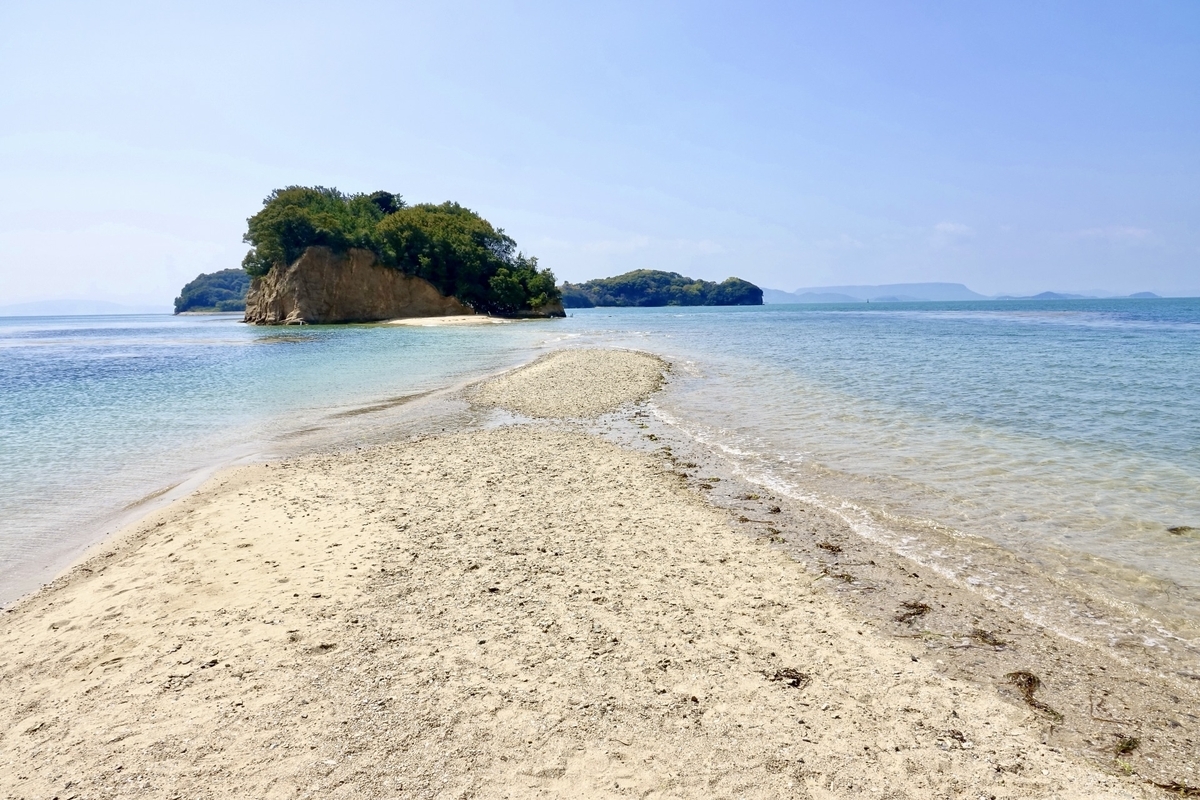 Angel Road’s sand path revealed at low tide against a vivid blue sea