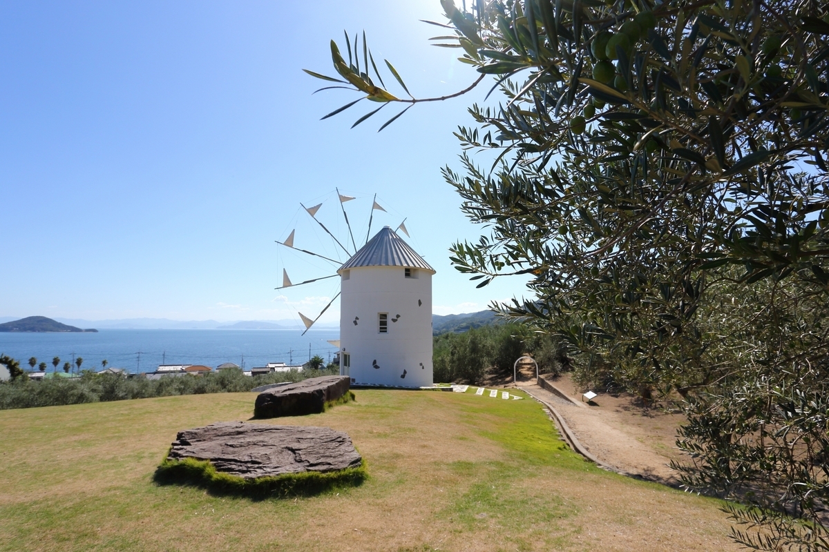 Shodoshima Olive Park with a large windmill on the grass and the Seto Inland Sea beyond.