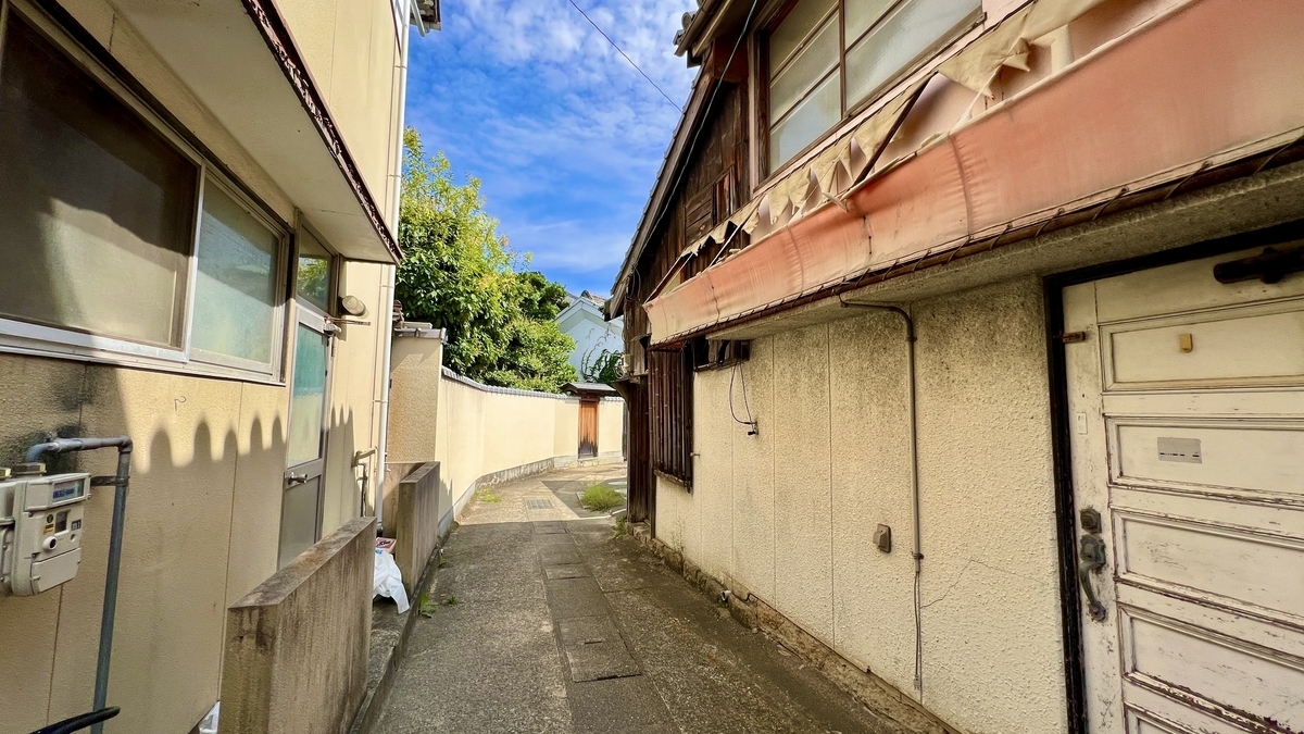 Tightly packed back alley with buildings on either side.