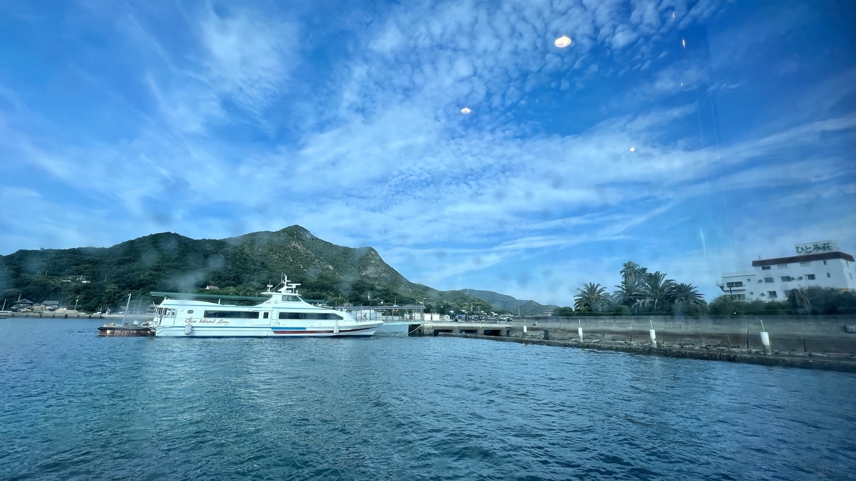 View of the sea and mountains from the high-speed boat leaving Tonosho Port.