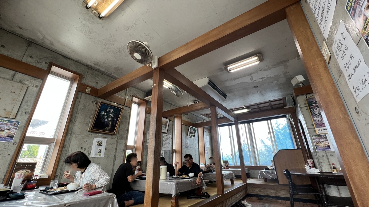 Table seating inside Yoshimi Shokudo with bright window-side seats