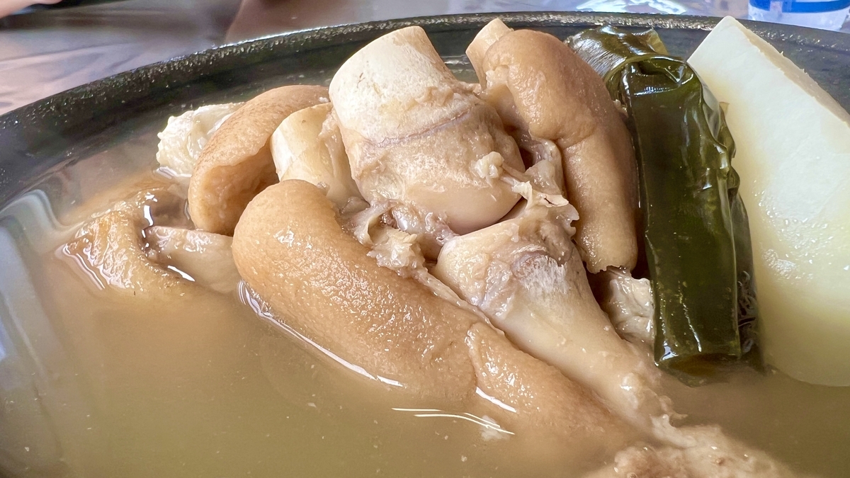 Large pieces of simmered pork trotters and kelp in a bowl of tebichi stew