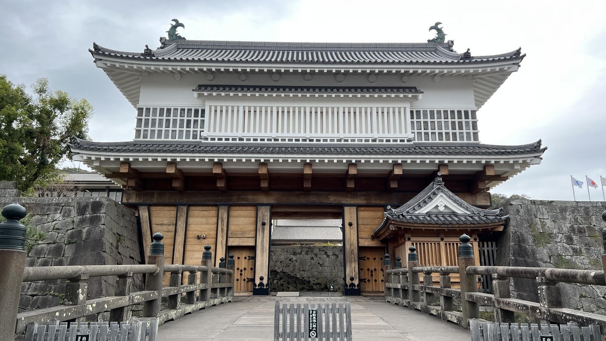 Panoramic view of the restored Goromon Gate built atop the stone walls and surrounded by the moat