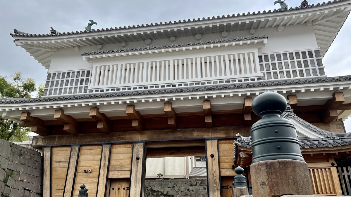 Upward view showing the wooden framework and tiled roof details of the Goromon Gate
