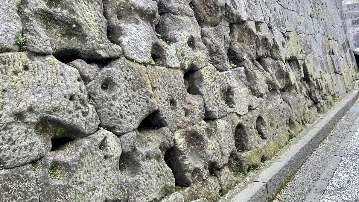 Close-up of the Kagoshima Castle stone walls covered with countless bullet marks from the Seinan War