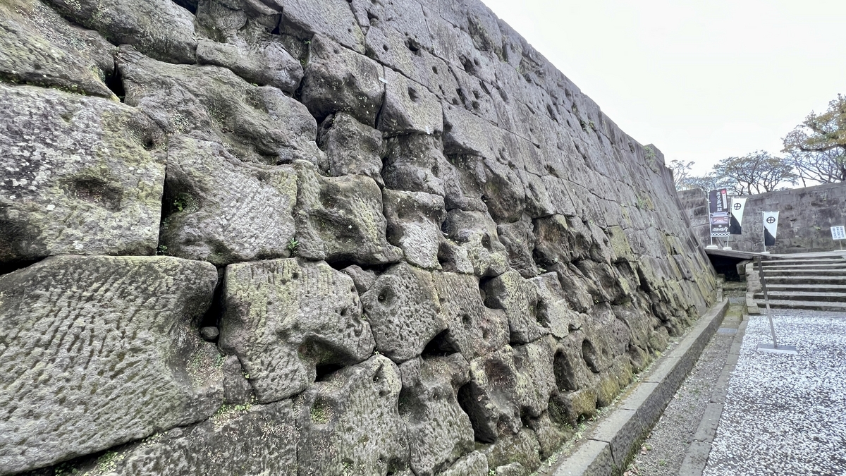 Surface of the stone wall showing bullet and shell marks that tell the story of the Seinan War