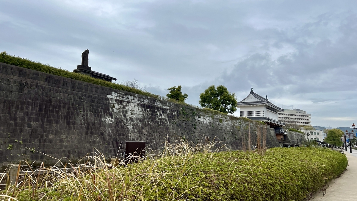 View of the Goromon Gate and surrounding stone walls reflected in the moat of Kagoshima Castle