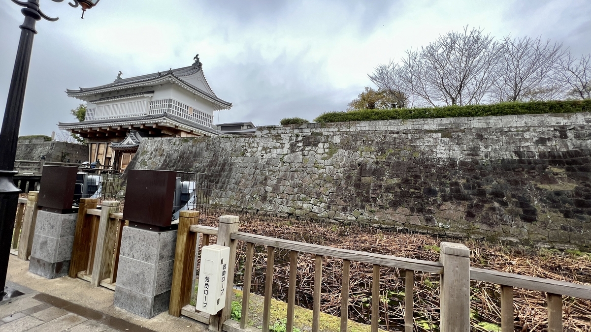 Outer view of the Kagoshima Castle gate and stone walls from outside the moat
