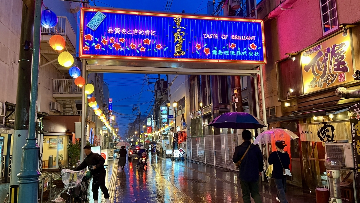 Night view of Chuo Street gate with rain-soaked pavement reflecting the lights