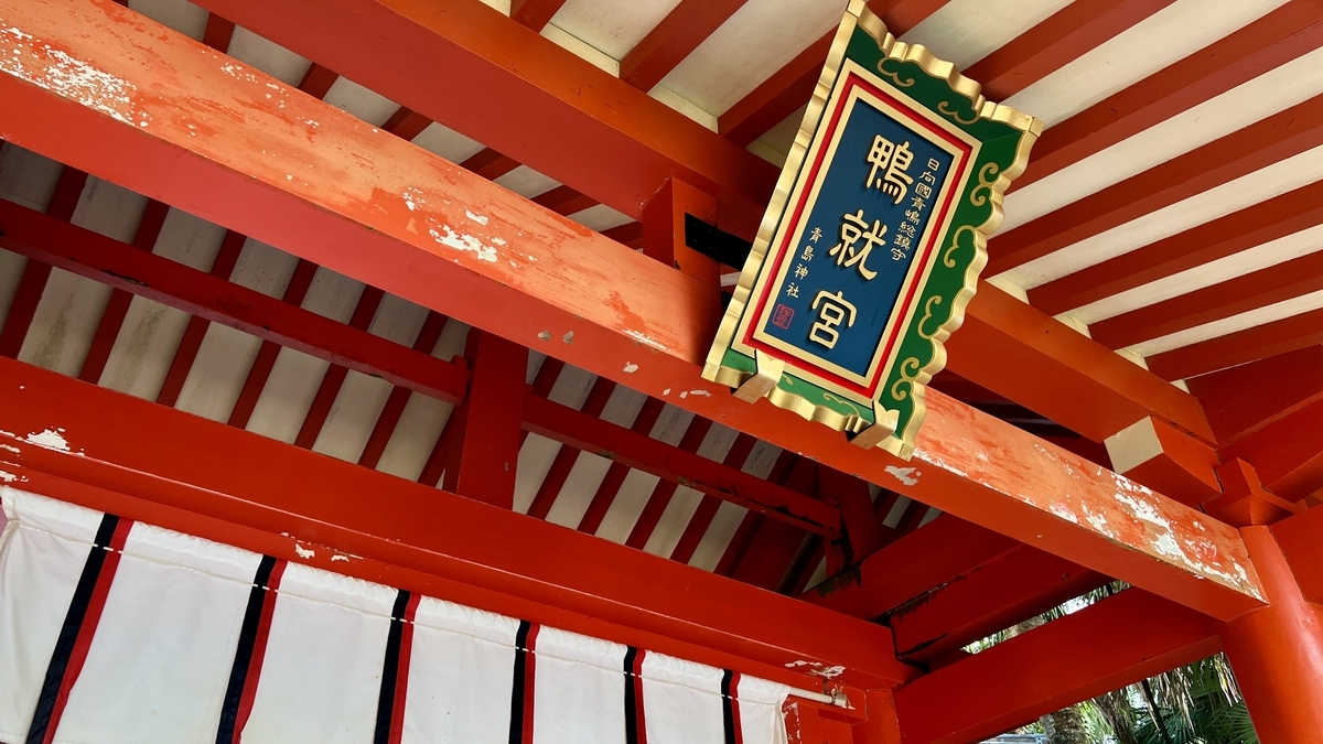 拝殿へ続く朱色の門を見上げた構図 木々の緑と門の朱色が鮮やかに映える