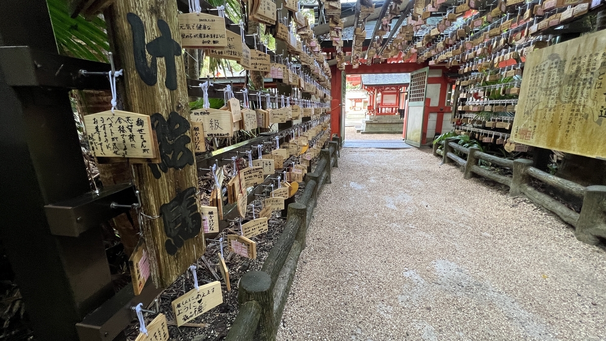 祈りの古道の出口付近から拝殿方向を撮影した様子 絵馬と朱色の建物が印象的に並ぶ
