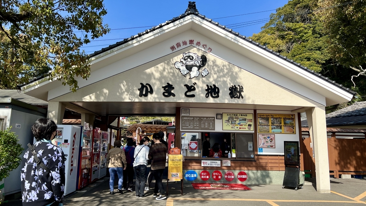 가마도 지고쿠 입구 게이트와 안내판 앞에 줄 선 관광객들, 푸른 하늘과 나무들
