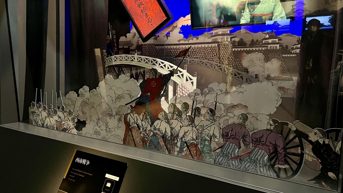 세이난 전쟁 전투를 묘사한 종이 오리기 병사들과 다리, 연기의 입체 전시