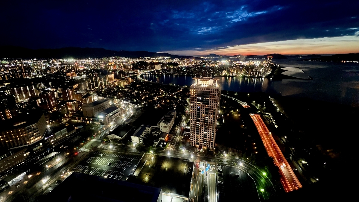 Night view around Hakata Bay with sunset afterglow and light trails along the waterfront