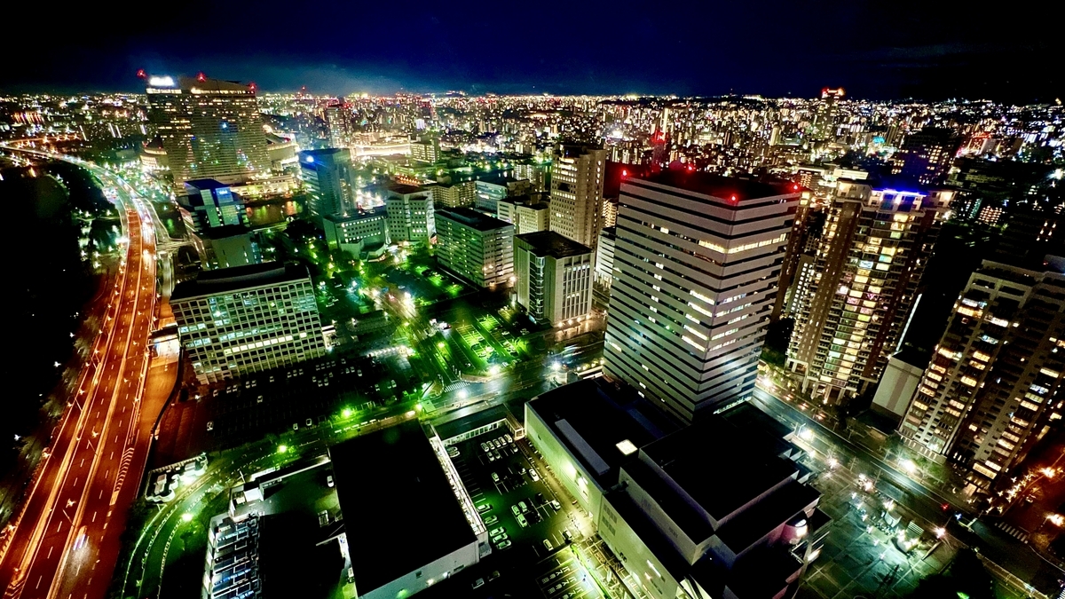 Night view of central Fukuoka with high-rise buildings and expressway light trails