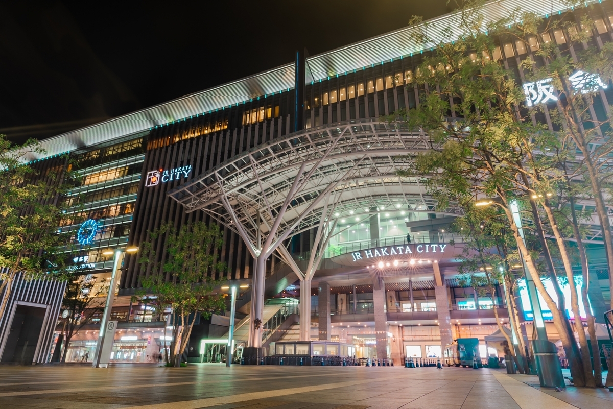 JR Hakata City station plaza at night with the arched roof illuminated