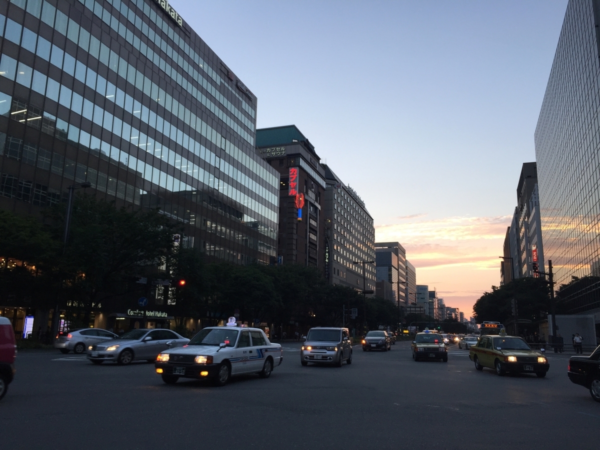 Taxis and cars on the main street near Wakiyamaguchi intersection during evening