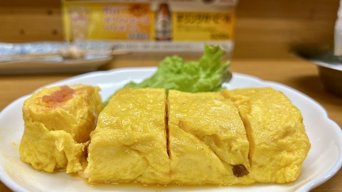 Tamagoyaki esponjoso con relleno de mentaiko servido con lechuga en un plato
