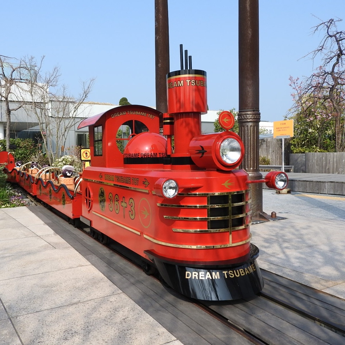 The vermilion front car of the mini Tsubame Train with round headlights