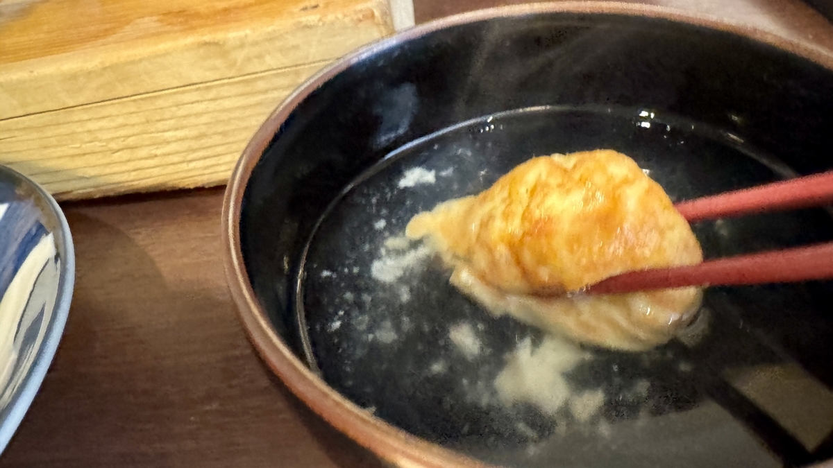 Dipping Akashiyaki in Dashi