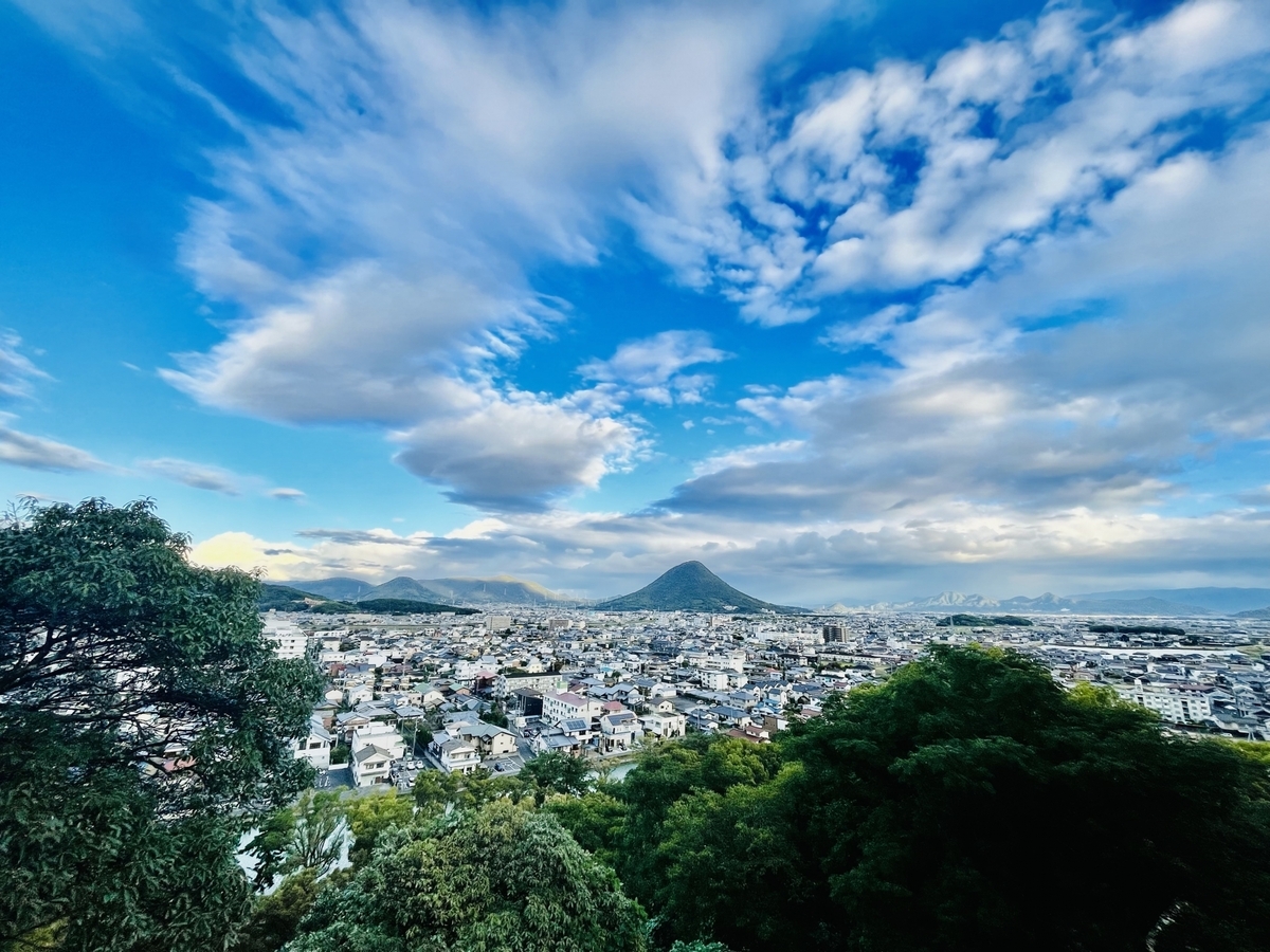A wide scenic view from Marugame Castle’s main enclosure, showing Mount Sanuki-Fuji and Marugame City.