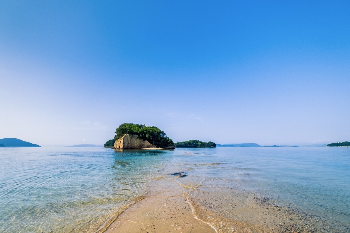 Angel Road’s sandbar revealed at low tide with small islets floating on a blue Seto Inland Sea