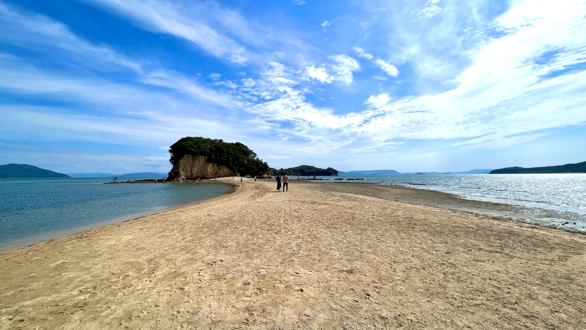 A bright blue sky with scattered clouds over the Angel Road sandbar and the Seto Inland Sea