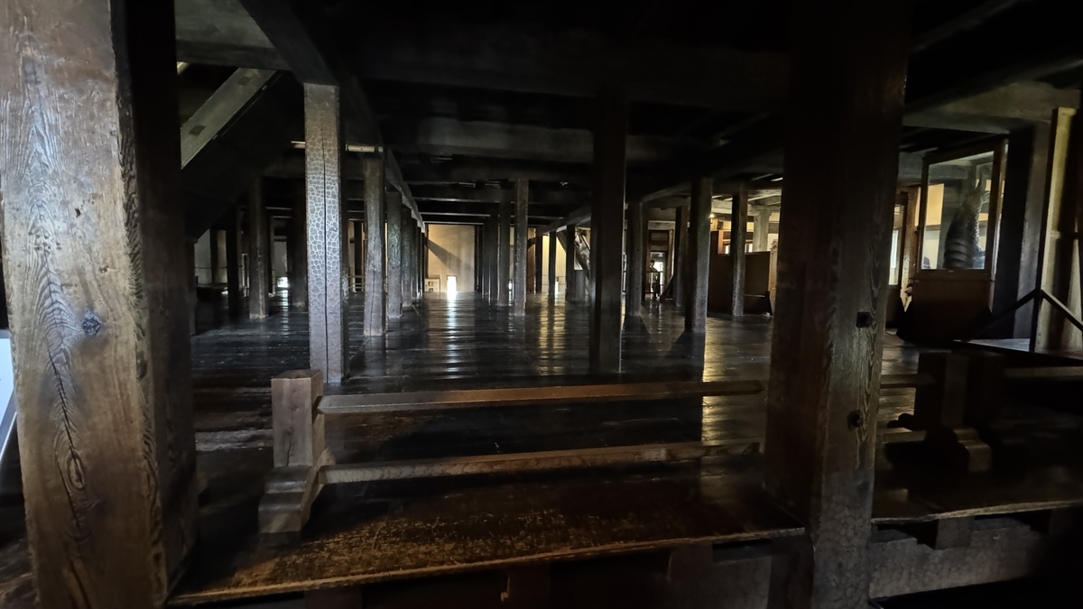 First floor of Matsumoto Castle keep with aligned wooden pillars and wide floor