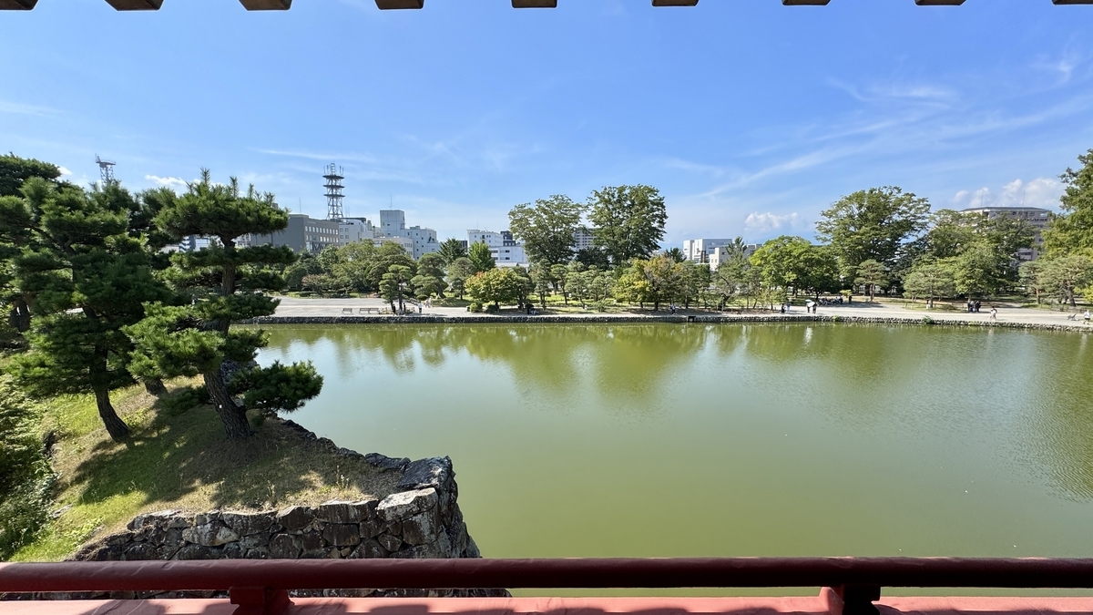 View of sky and garden reflected in moat from Moon-Viewing Turret