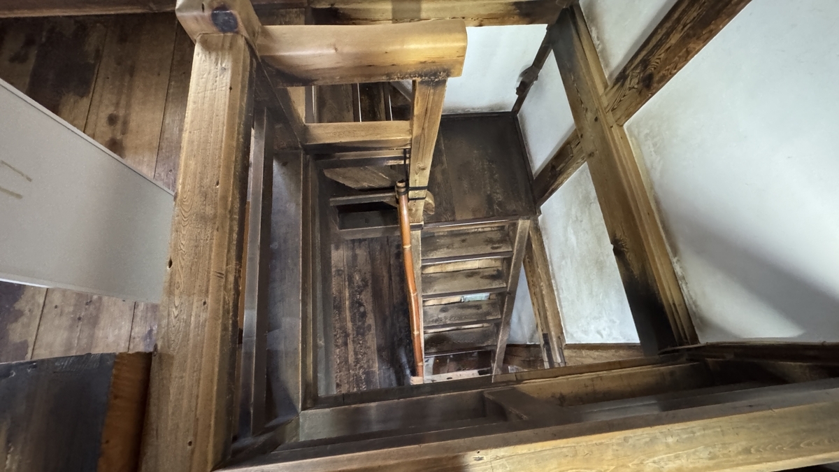 Looking down a steep staircase from above inside the keep