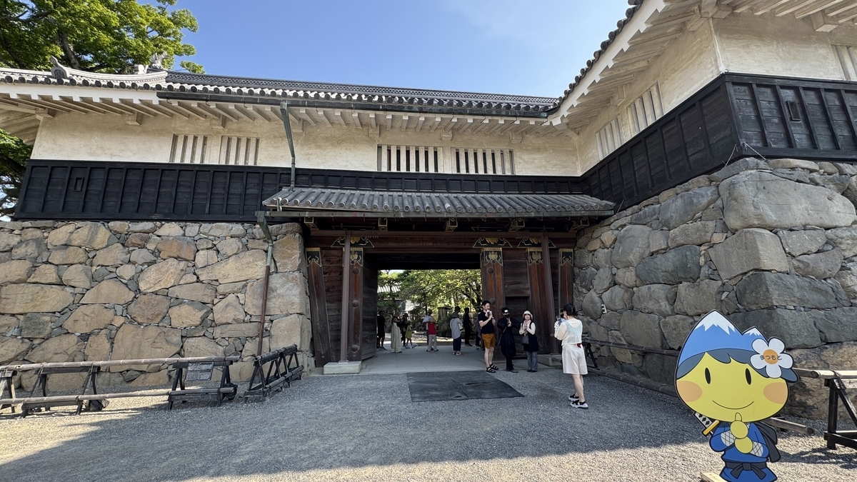 Imposing Kuro Gate surrounded by stone walls, serving as the main entrance