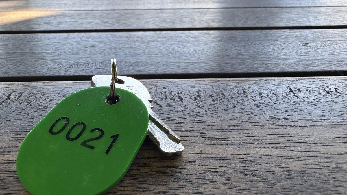 Locker key and numbered tag placed on a surface