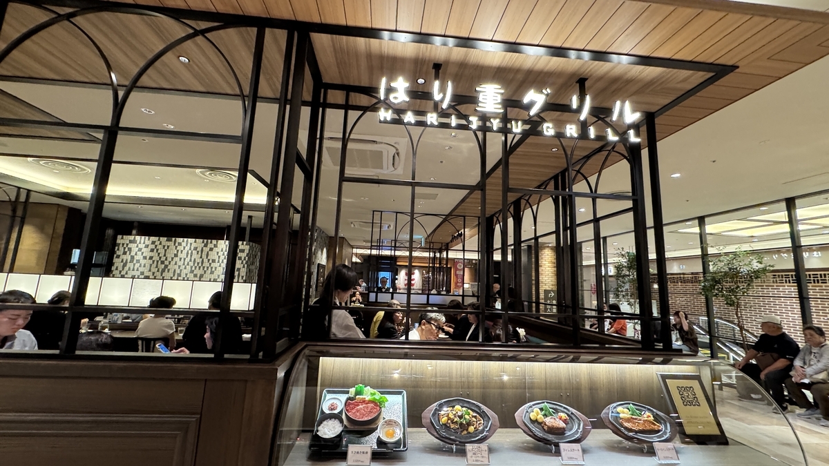 Exterior of one of the restaurants in the Hanshin Dai-Shokudo restaurant area. The soft lighting and wooden interior create an elegant atmosphere.