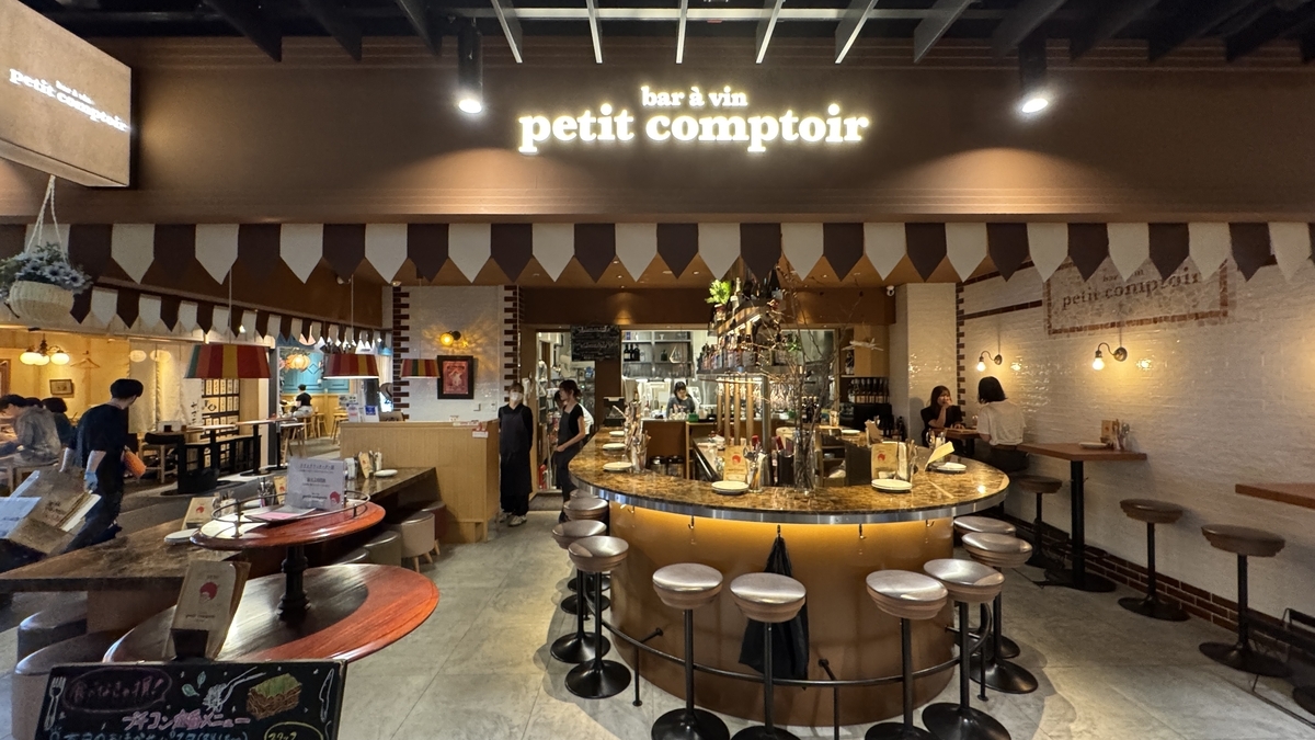 petit comptoirの店内に並ぶ丸テーブルと温かな照明が印象的なバル空間
