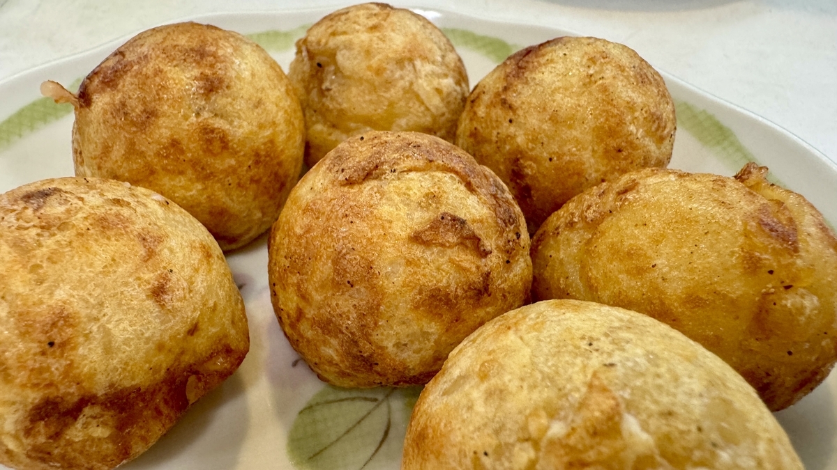 Close-up of takoyaki showing the golden surface and savory dashi aroma