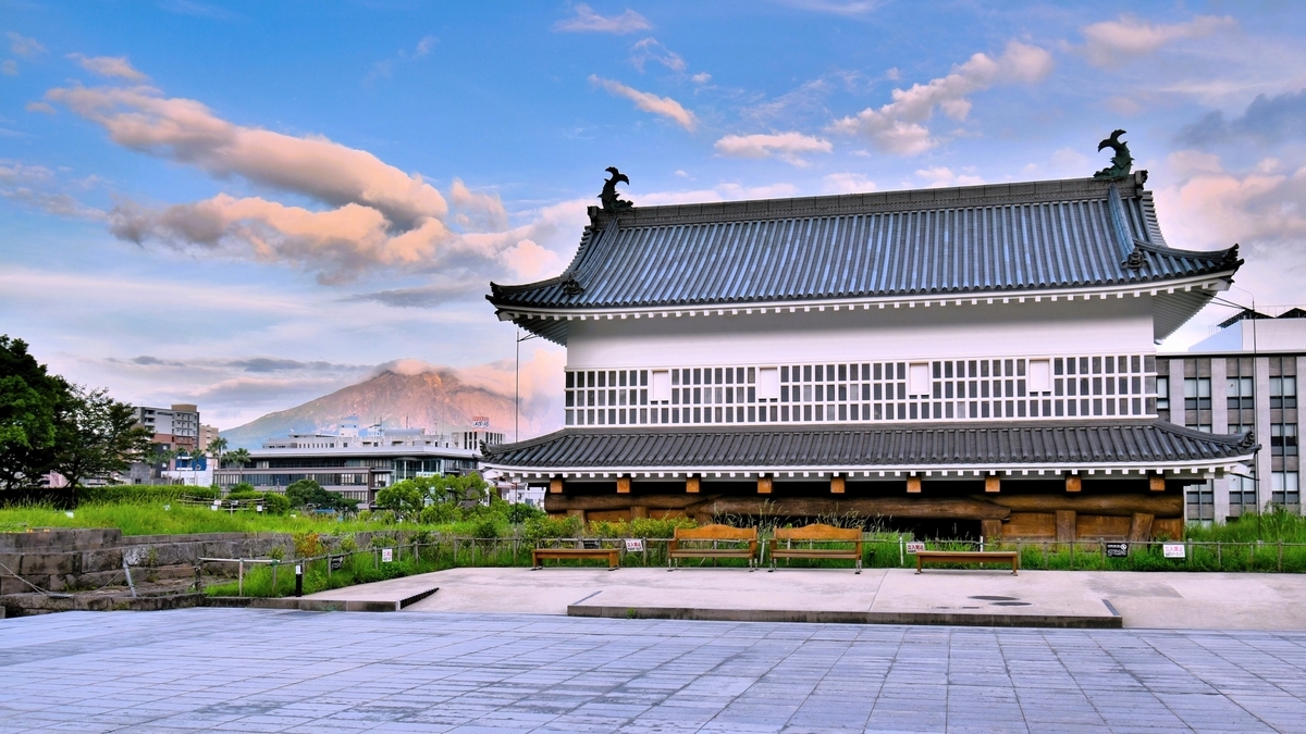 Sweeping evening view of Kagoshima Castle Ruins with Goromon Gate and Sakurajima in the background