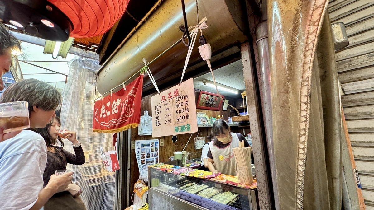 People waiting calmly in line along the backstreet