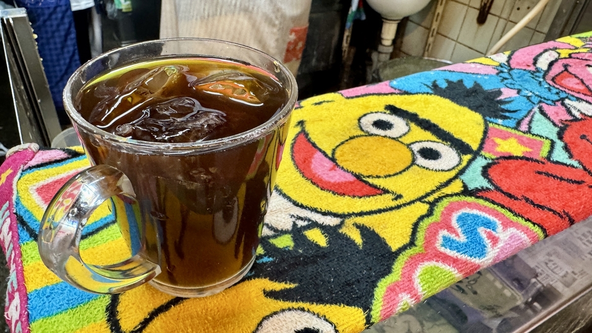 A cup of tea and colorful towel placed on the counter