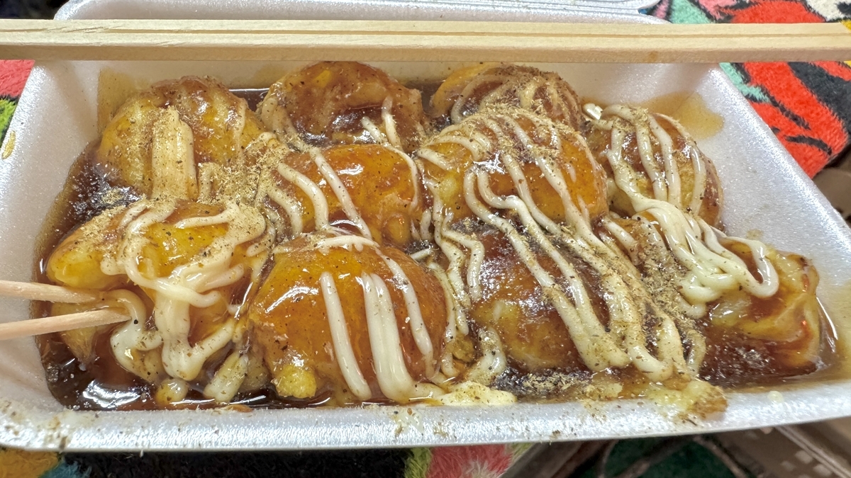Golden, creamy takoyaki coated lightly in sauce
