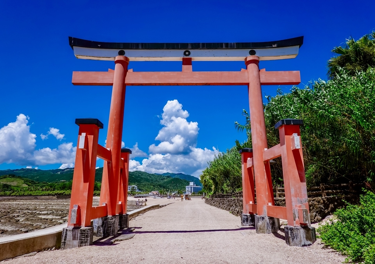 Vermilion torii gate at the entrance to Aoshima Shrine approach and seaside path