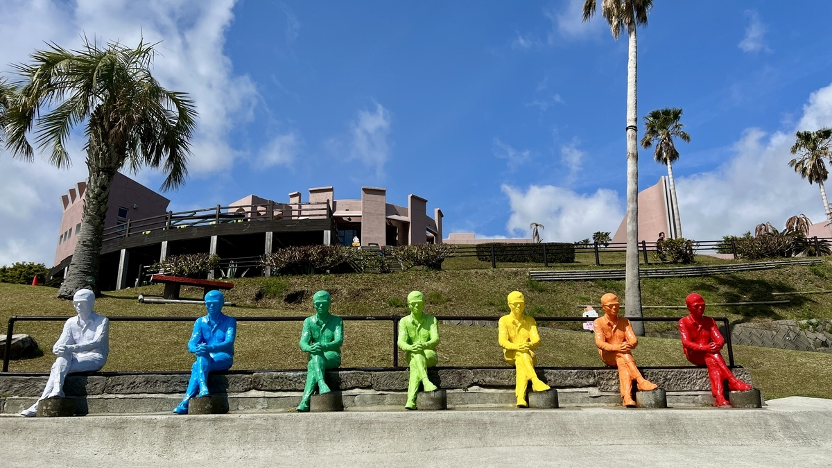 Colorful Moai statues lined up on a hill at Sun Messe Nichinan