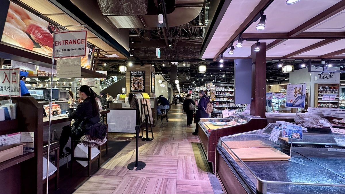 飲食カウンターと食品売り場が並ぶ心斎橋フードホールの通路