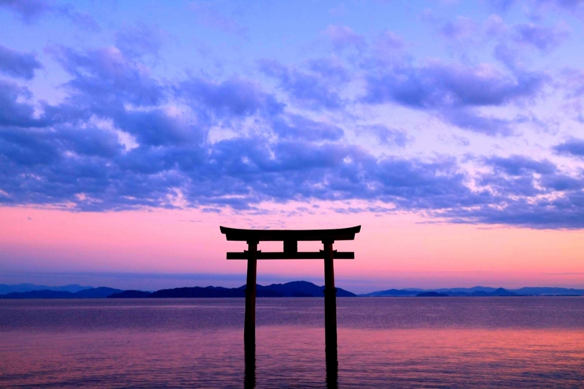 黄昏时分矗立在湖中的黑色鸟居