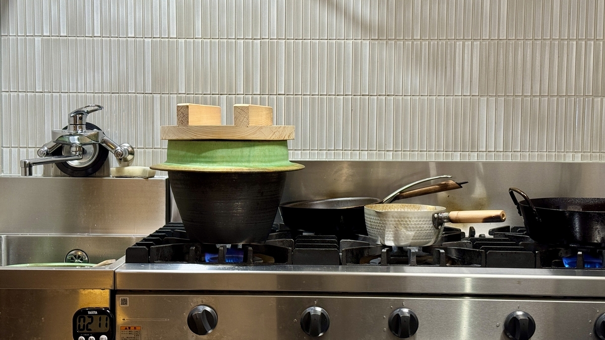 A green Hagama rice pot on the gas stove in the kitchen